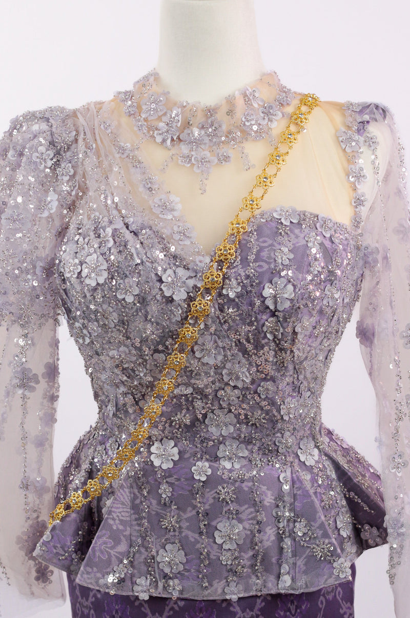 Mannequin wearing a purple and gold embroidered outfit on a white background