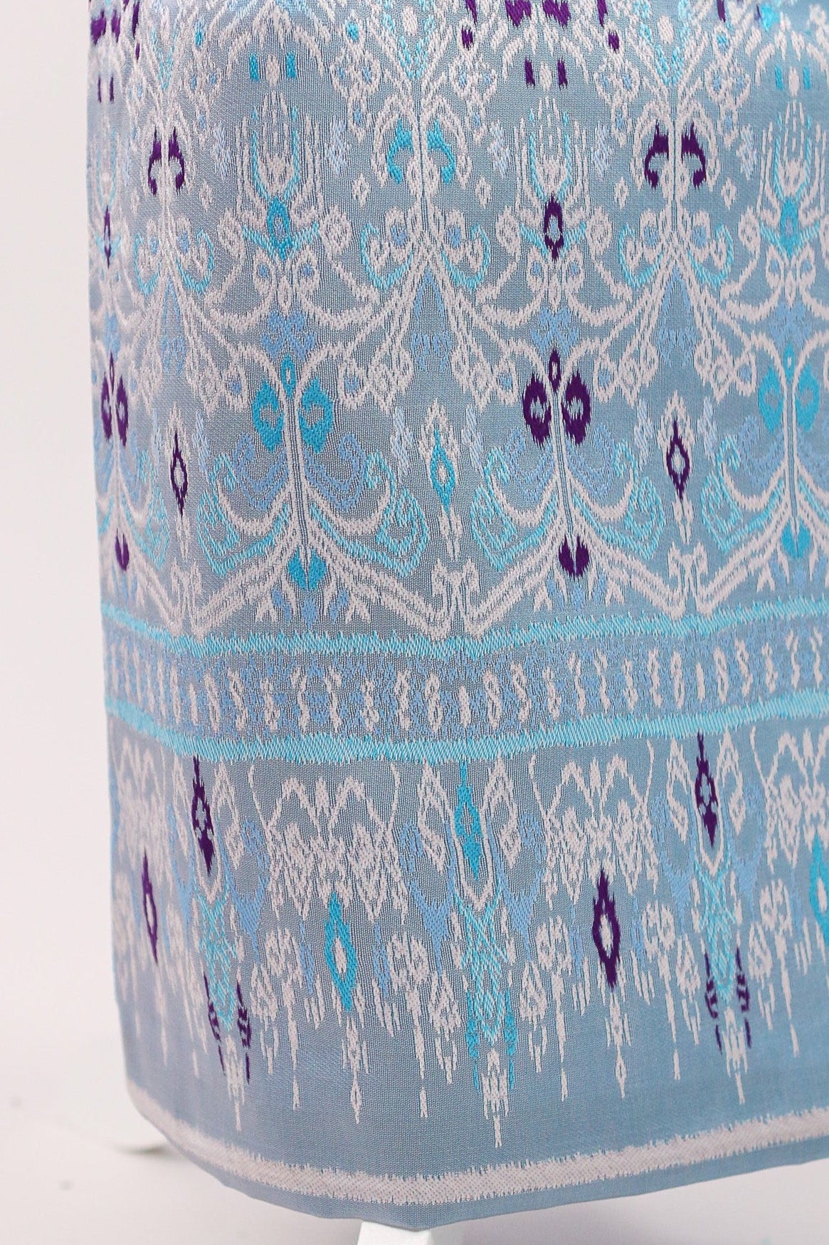 Blue and white patterned fabric on a white stand