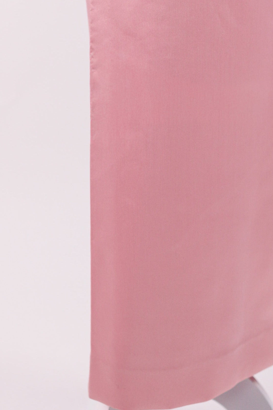 Pink skirt on a mannequin against a white background