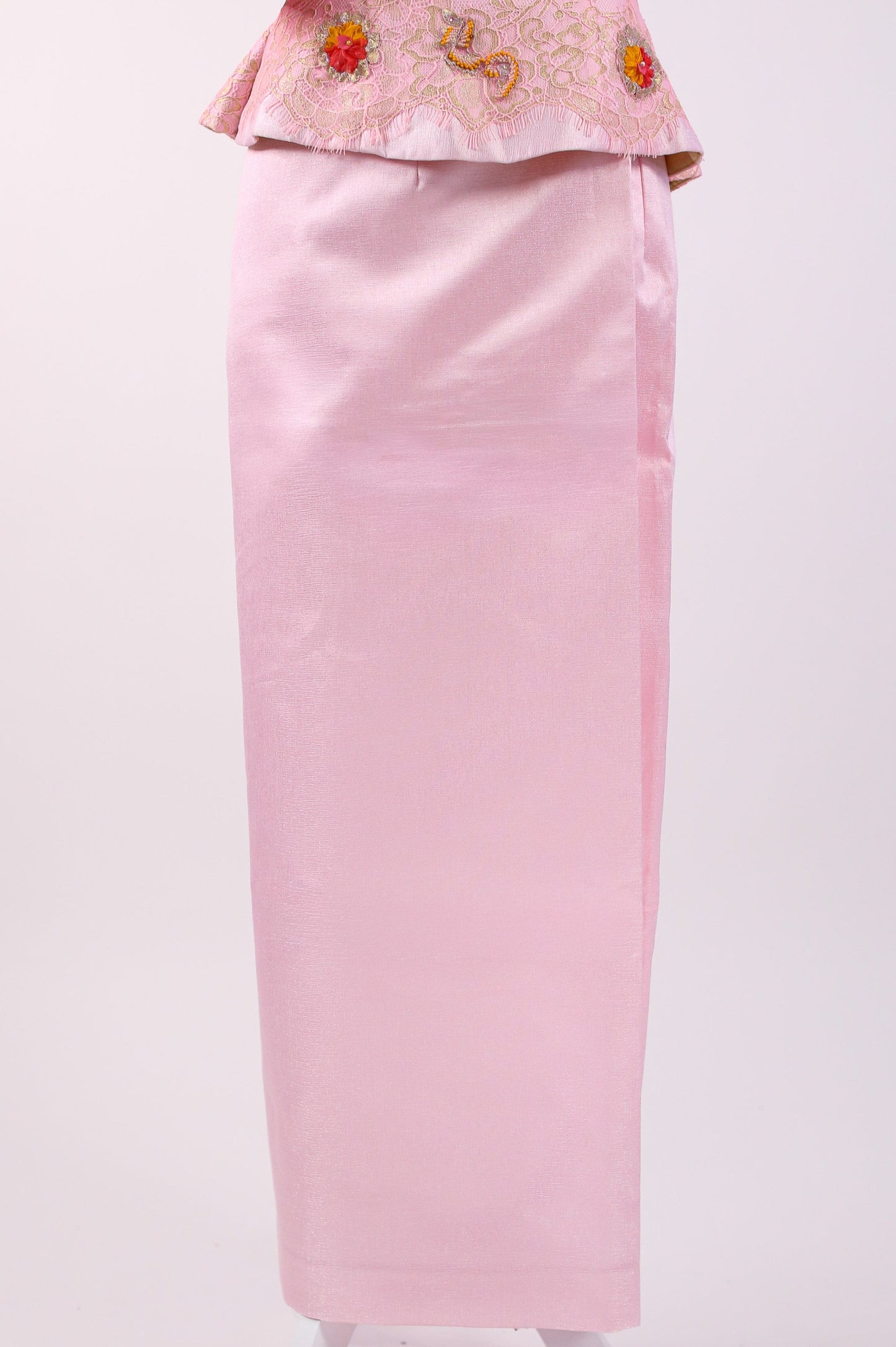 Traditional pink outfit with floral embroidery on a white background
