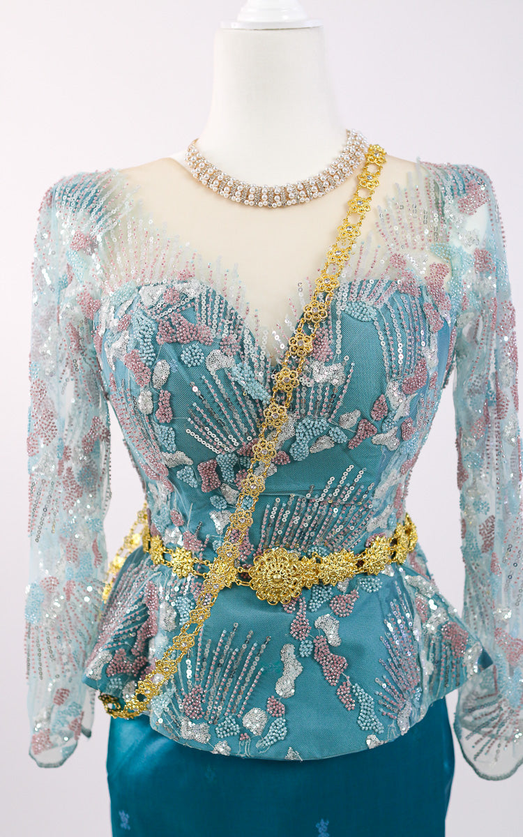 Decorative top with intricate patterns and embellishments on a mannequin.