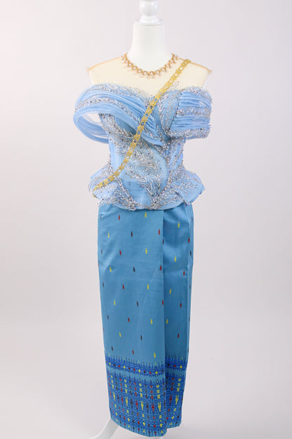 Mannequin wearing a blue outfit with intricate patterns on a white background