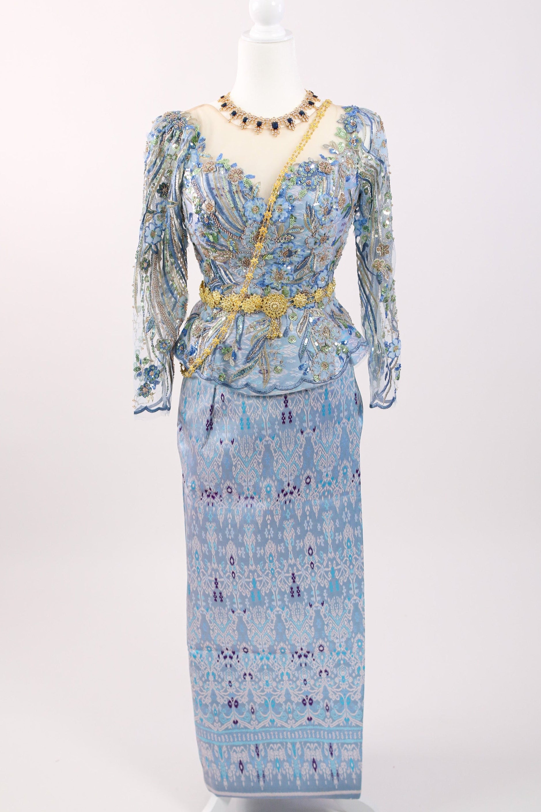 Floral patterned dress on a mannequin against a white background