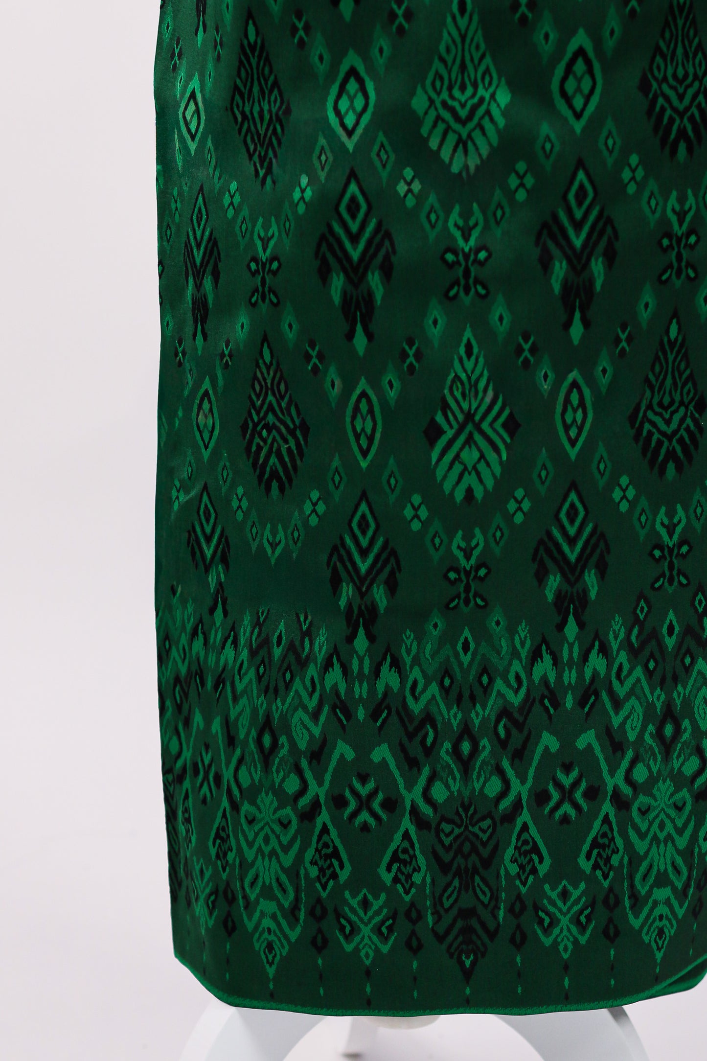 Green patterned fabric on a white background