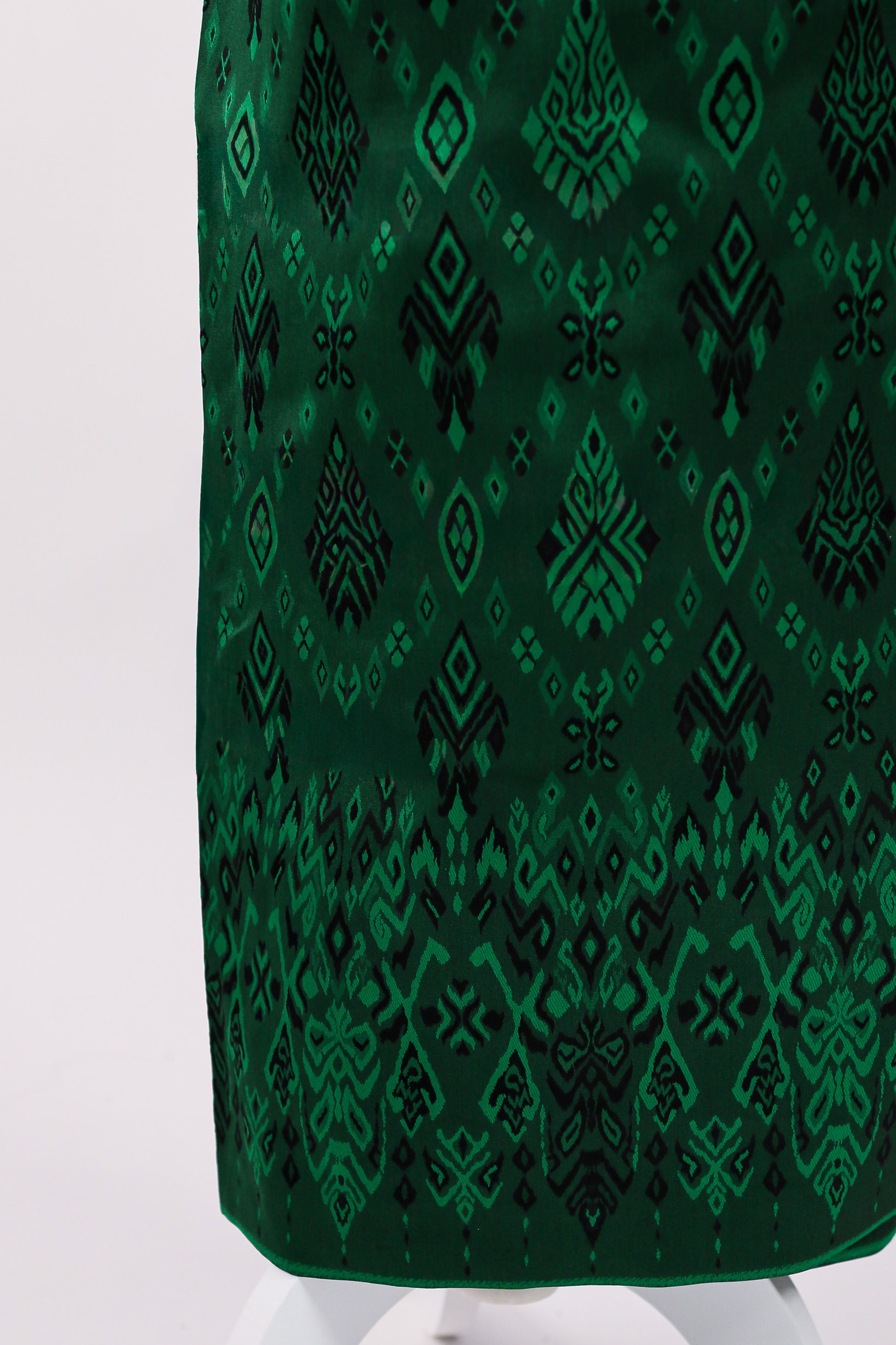 Green patterned fabric on a white background