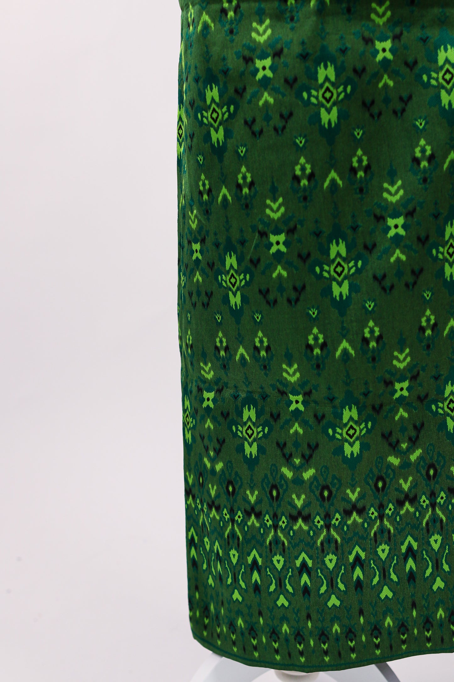 Green patterned fabric on a white background