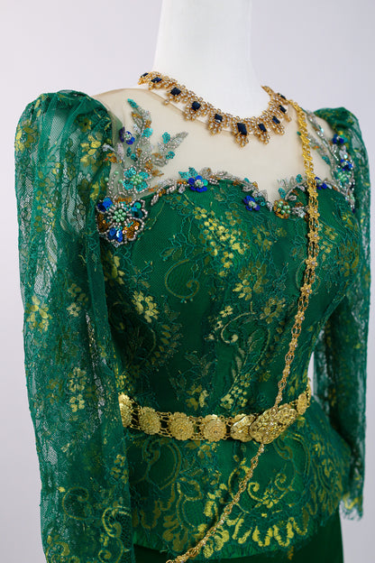 Green embroidered garment with gold and blue embellishments on a mannequin against a white background