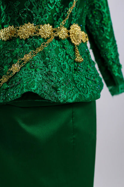 Green lace top with gold embellishments on a plain background