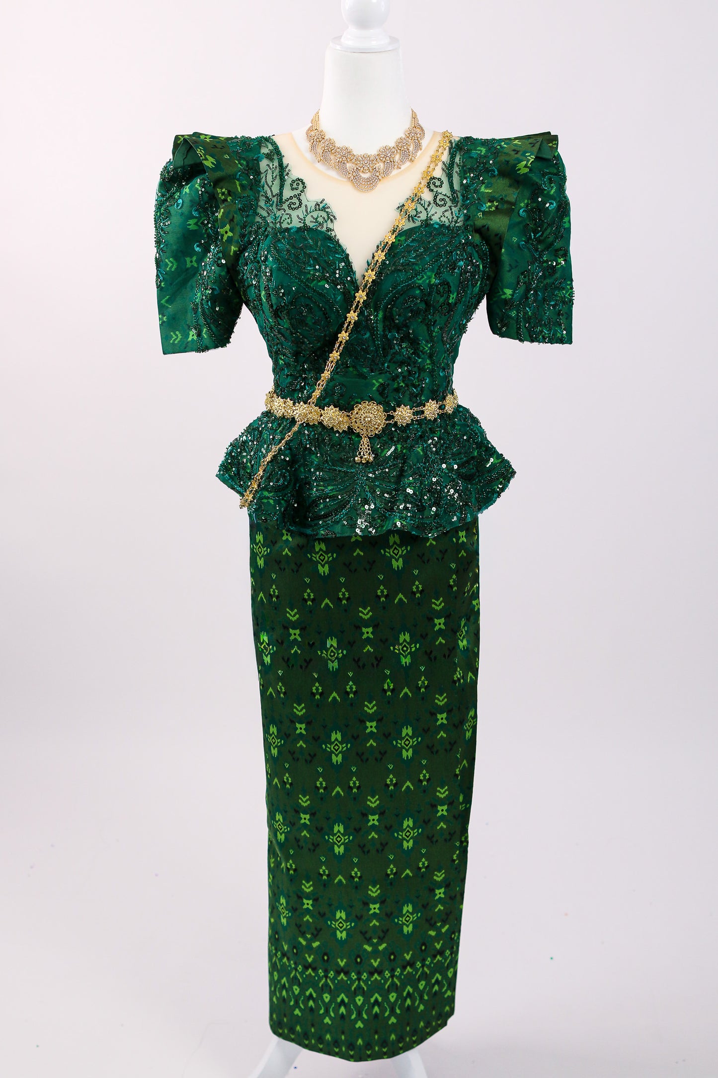 Green patterned dress with a matching skirt on a white background