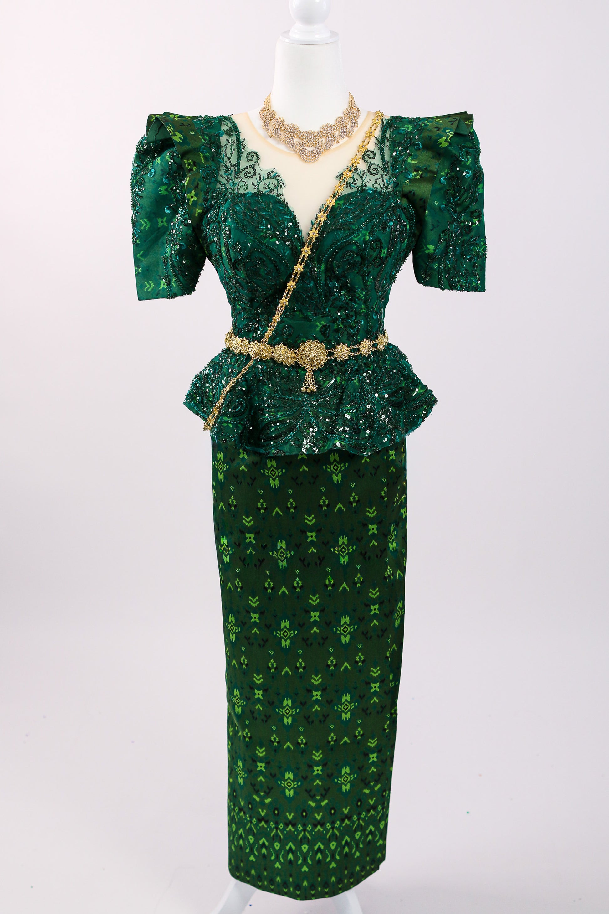 Green patterned dress with a matching skirt on a white background