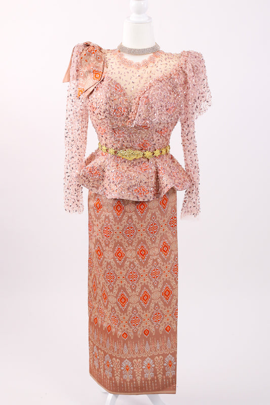 Traditional outfit with a patterned top and long skirt on a mannequin against a white background