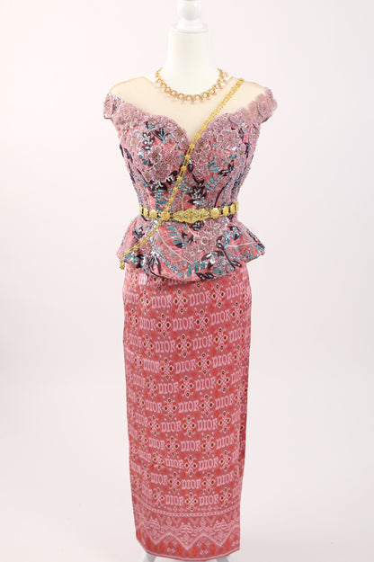 Pink dress with floral patterns on a mannequin against a white background