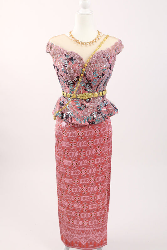 Pink dress with floral patterns on a mannequin against a white background
