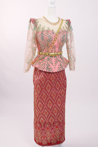 Traditional outfit with a pink top and red skirt on a mannequin against a white background