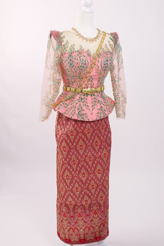 Traditional outfit with a pink top and red skirt on a mannequin against a white background