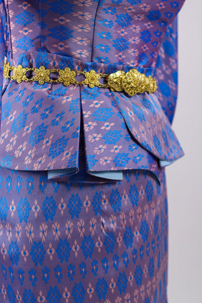 Blue patterned outfit with a gold belt on a light gray background