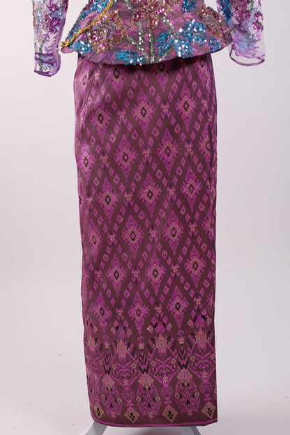 Traditional outfit with a sequined top and patterned skirt on a white background