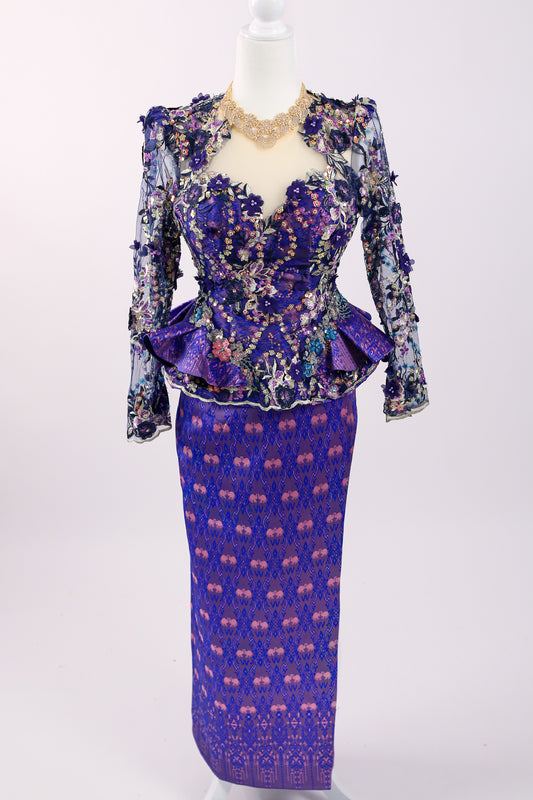 Purple and blue patterned dress on a mannequin against a white background