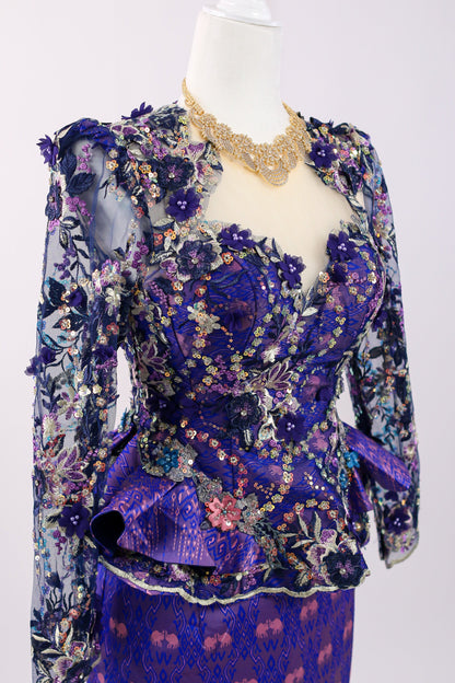 Mannequin wearing a floral and ruffled purple outfit on a white background