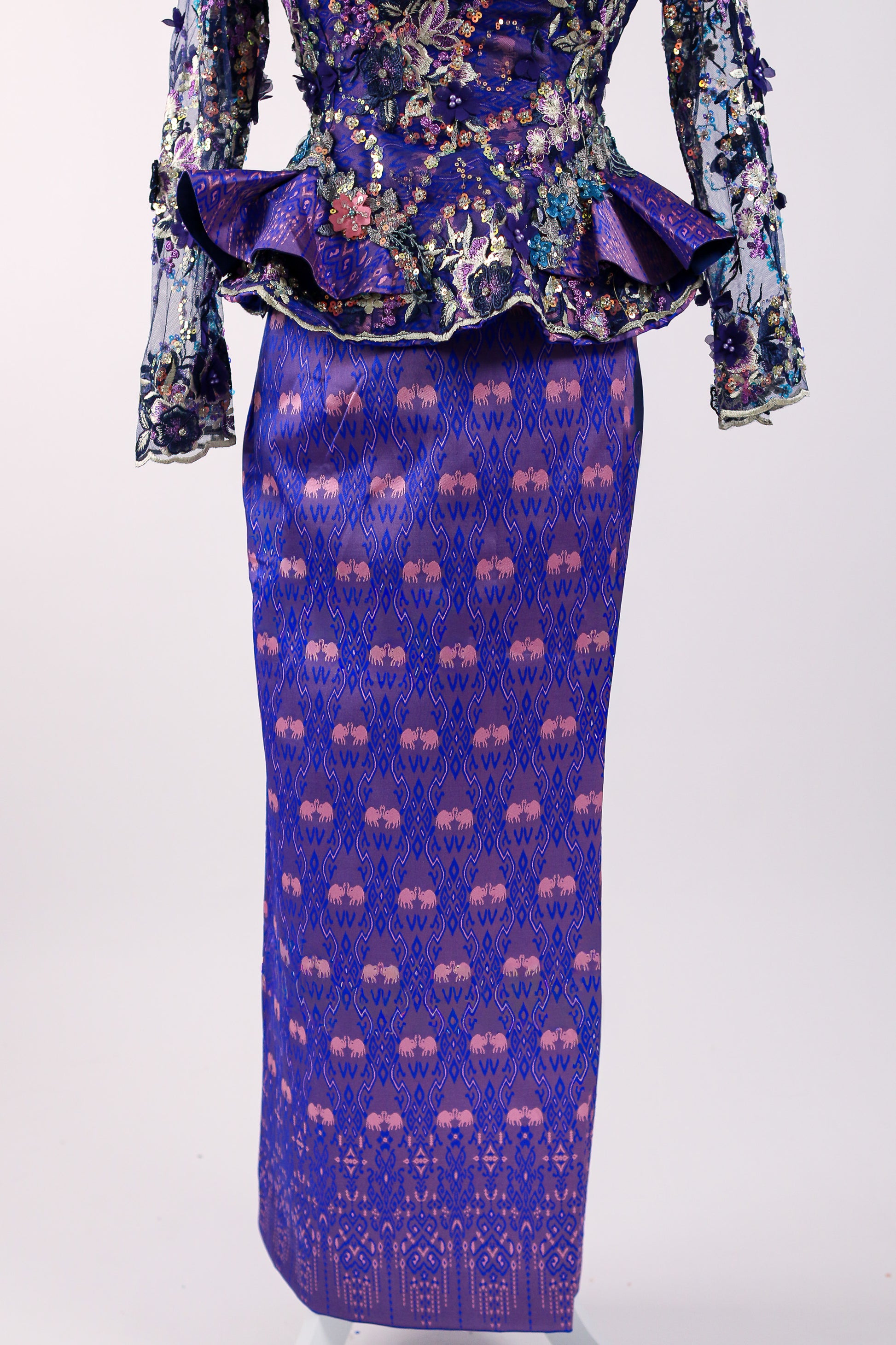 Purple patterned skirt with matching top on a white background