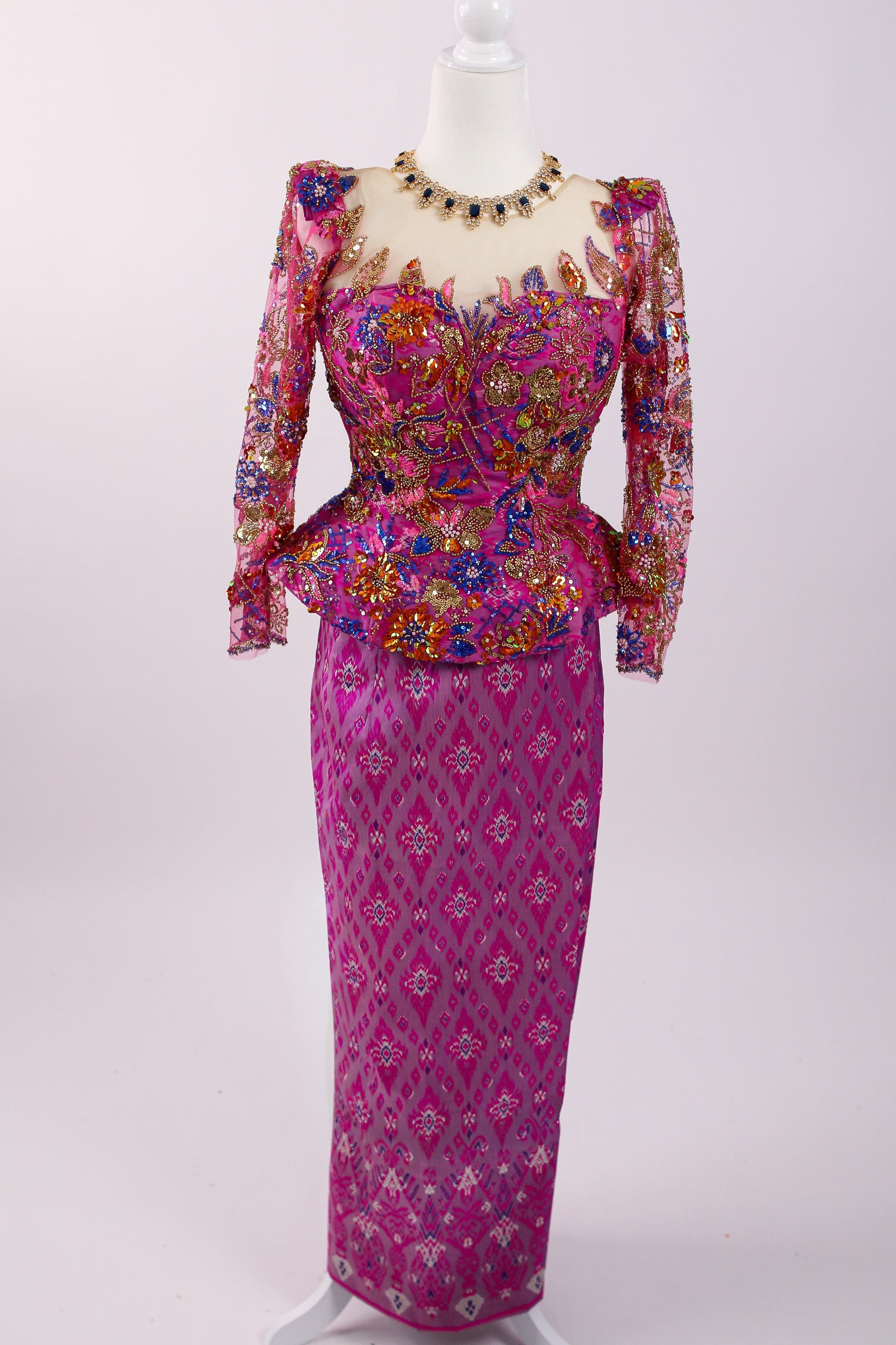 Colorful traditional outfit on a mannequin against a white background