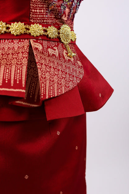Red traditional outfit with gold embroidery and decorative elements on a white background