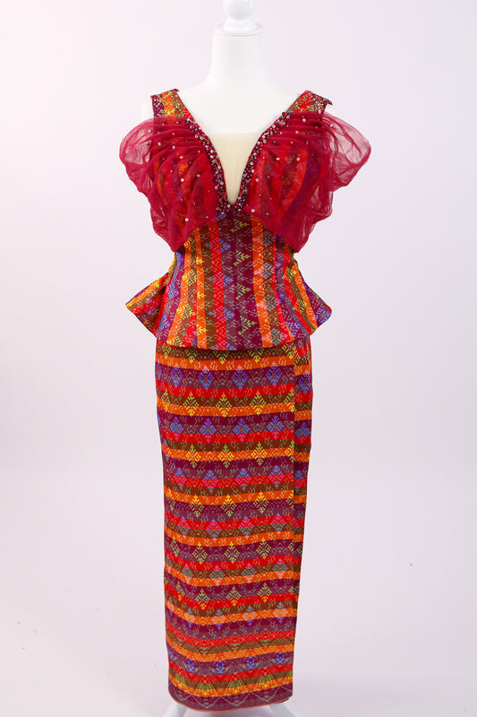 Colorful dress with ruffled top and patterned skirt on a mannequin against a white background