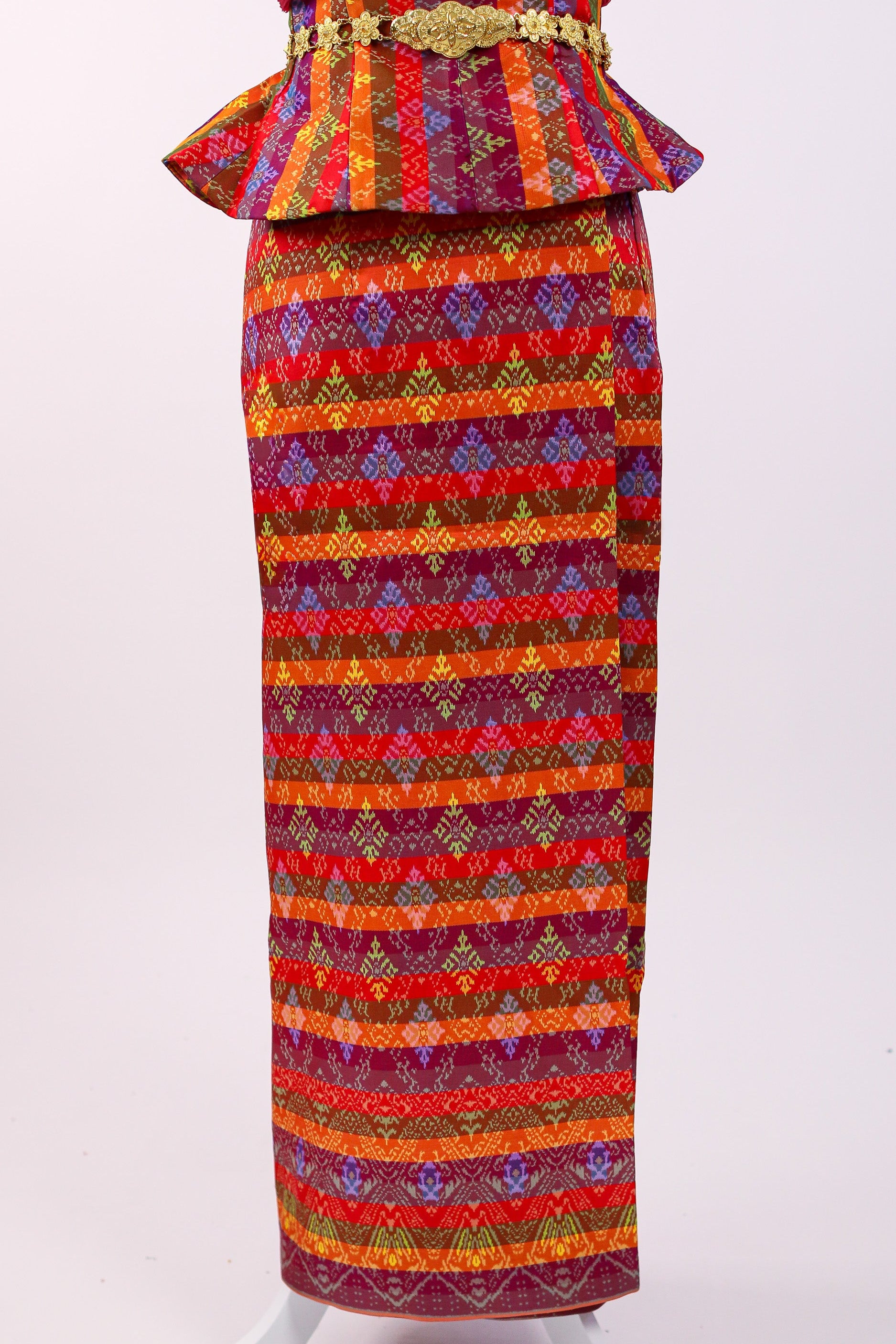 Colorful traditional outfit with a patterned top and skirt on a white background
