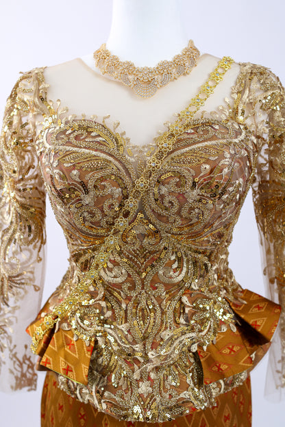 Decorative top with intricate gold embroidery on a white background