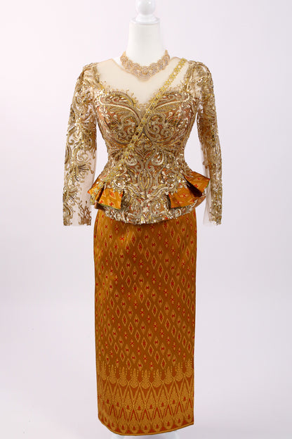 Gold and brown patterned dress on a mannequin against a white background