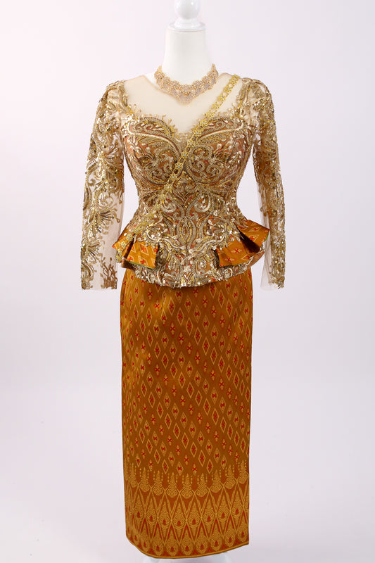 Gold and brown patterned dress on a mannequin against a white background