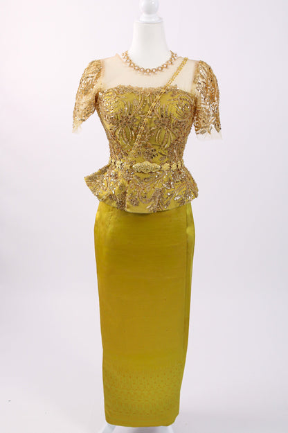 Gold lace dress on a mannequin against a white background