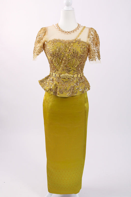Gold lace dress on a mannequin against a white background